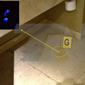 Vista general de localización de indicio “G” encontrado en piso de baño debajo del lavatorio utilizando el reactivo “blue star” (manchas quimioluminicentes por encharcamiento) (Foto: Fuentes judiciales)